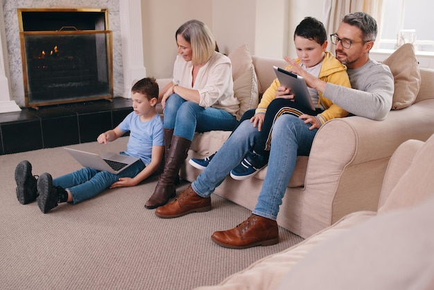 In need of a better data plan Shot of a young family bonding while using their electronic devices together at home