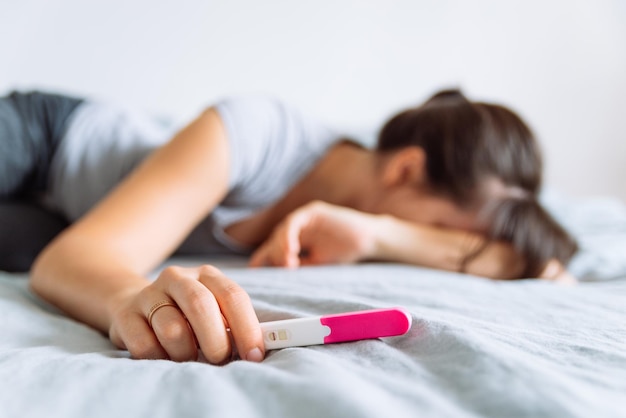 negative pregnancy test sad woman on background