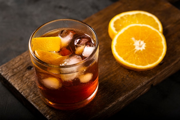 Negroni cocktail with orange on dark background