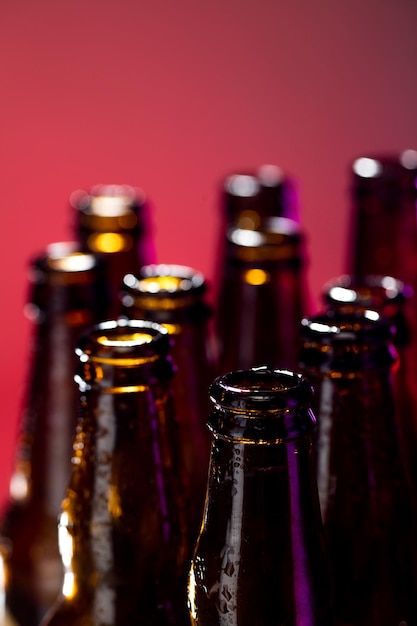 Neon colored beer bottles close up on bright studio background