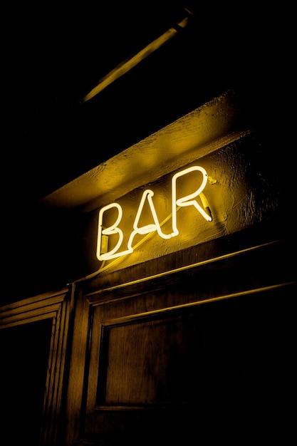 Photo neon inscription bar on the wall neon inscription bar in different colors neon inscription bar