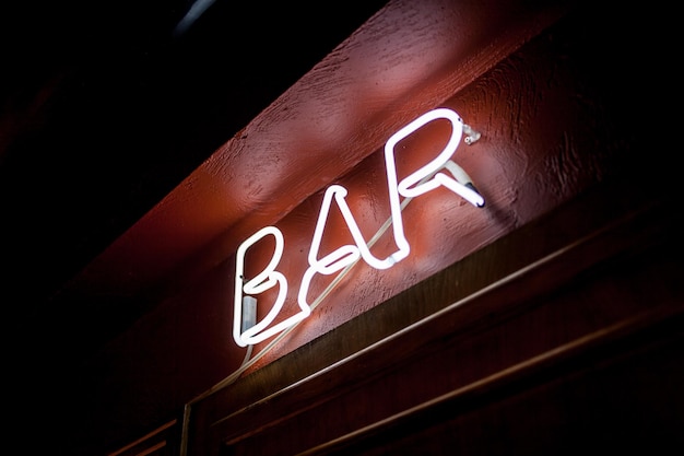 Photo neon inscription bar on the wall neon inscription bar in different colors neon inscription bar