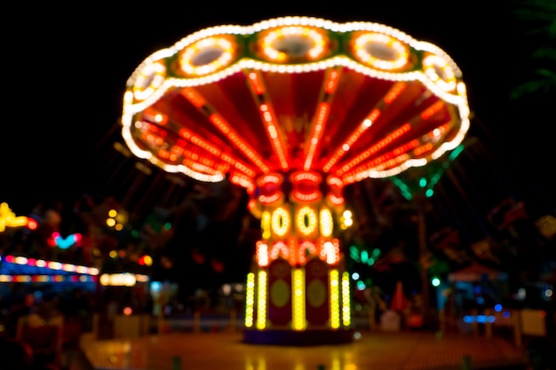 Neon lights on a chain carousel in the amusement park