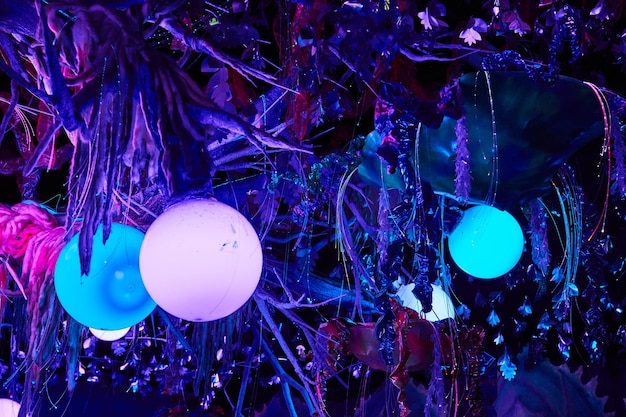 Neon lights and orbs on tree in art gallery