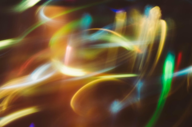 Neon multicolor glowing lines. Defocused gleam in motion. Dark abstract art background.