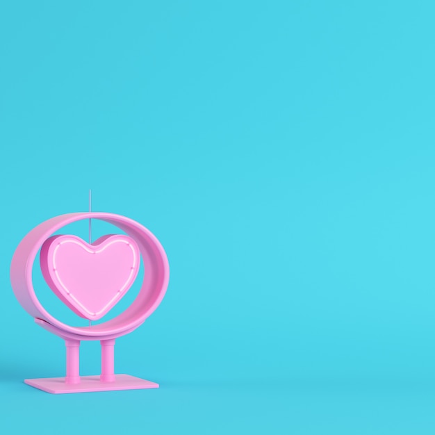 Neon, pink heart shape in frame on bright blue background