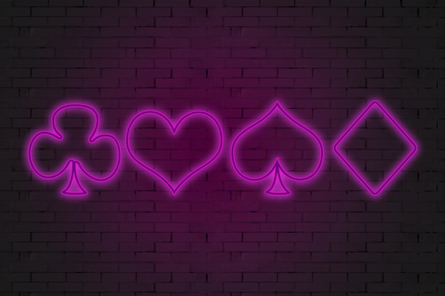 Neon playing cards on a brick wall