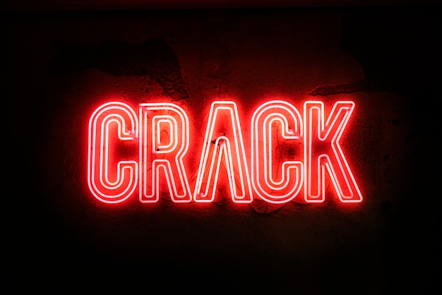 Neon sign on a broken wall - Crack