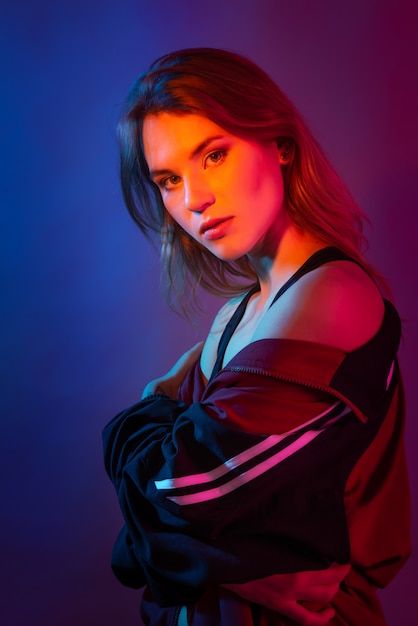 Photo neon style woman portrait in purple, blue, and pink lights