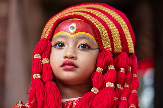 ネパールのカトマンズのクマリ・プジャの機会に、生きている女神クマリをドレスアップするネパールの女の子
