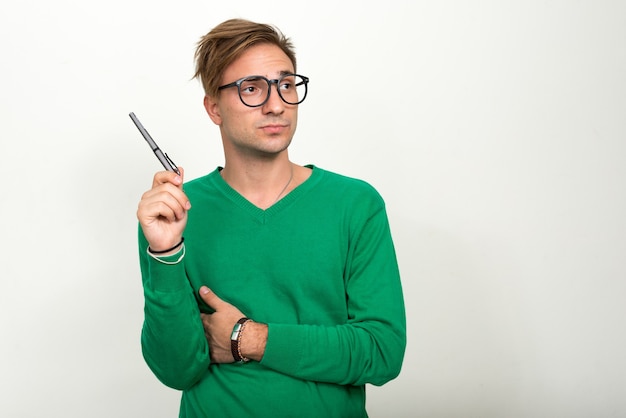  nerd man with blond hair against white wall