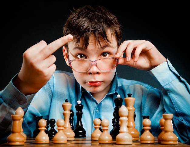 Nerd play chess on a black  background