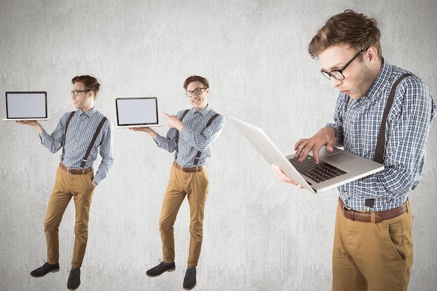 Nerd with laptop against white and grey background