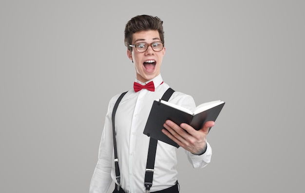 Nerdy guy reading notes in gray studio