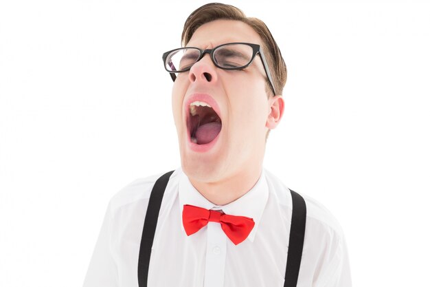 Nerdy hipster yawning in suspenders and bow tie