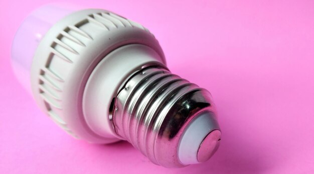 nergy saving LED light bulb on pink background Energy saving concept