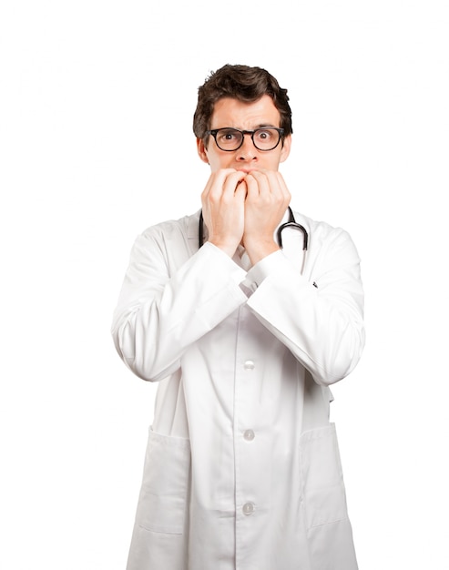 Nervous doctor against white background