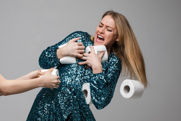 Nervous lady is fighting over toilet paper