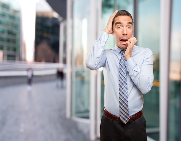 Nervous young businessman posing