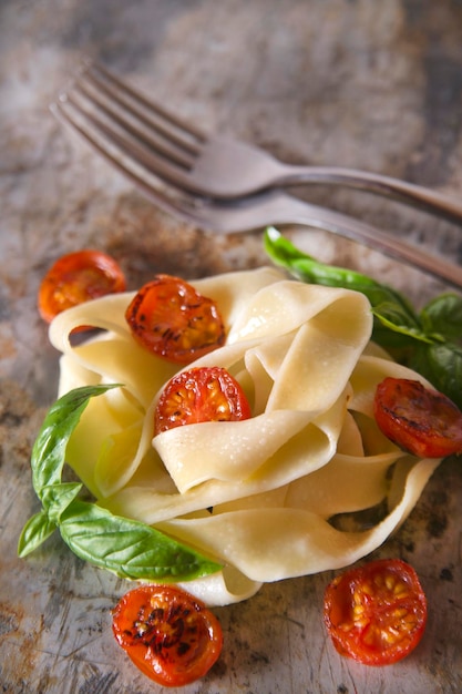 Nest of pasta with basil and tomato