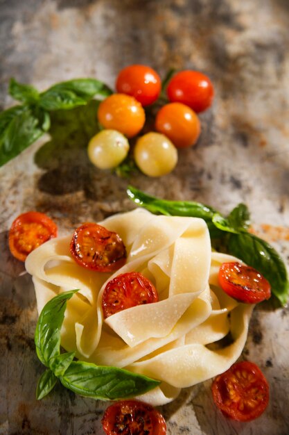 Nest of pasta with basil and tomato