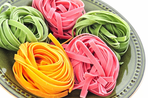 Photo nests of colorful pasta tagliatelle