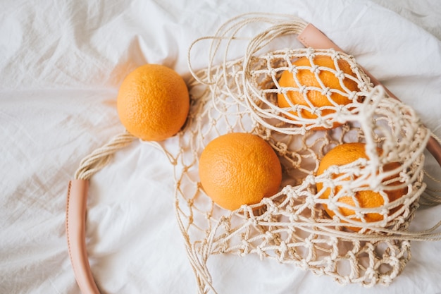 Net eco bag with fresh oranges