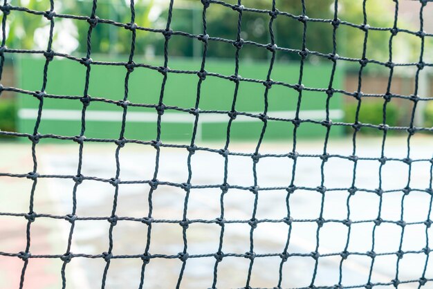 Net with empty tennis court background