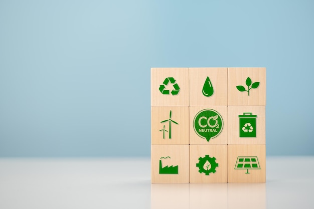Чистый нуль и углеродно-нейтральная концепция Чистый нулевой уровень выбросов парниковых газов Целевой показатель климатически нейтральной долгосрочной стратегии деревянные кубики с зеленым значком чистого нуля и зеленым значком на синем фоне