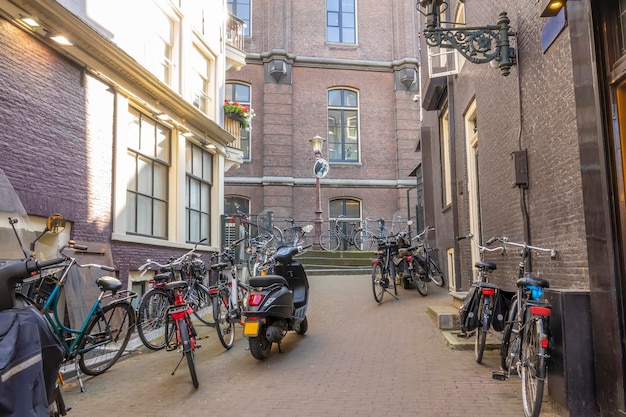 Netherlands Sunny day in Amsterdam Small Side Street With Bicycles and Scooters