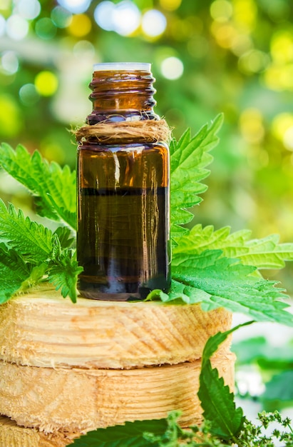 The nettle extract in a small jar. Selective focus.