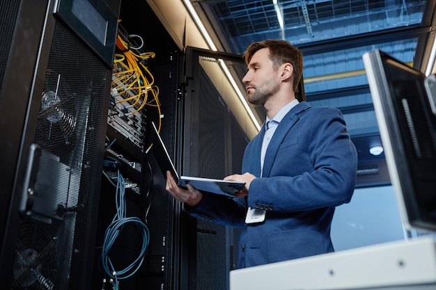 Network engineer inspecting servers