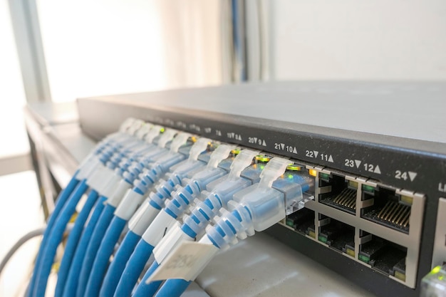 Network switch and ethernet cables in rack cabinet Computer and information network system technologyxA