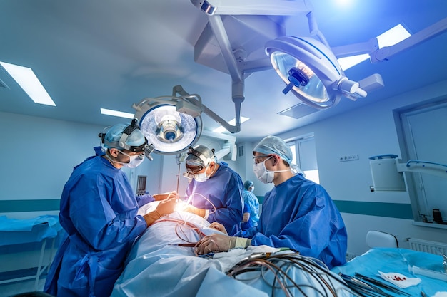 Neurourgeons are operating with medical robotic surgery machine\
modern automated medical device surgical room in hospital with\
robotic technology equipment machine arm neurosurgeon