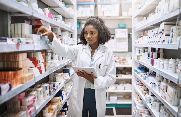 Never fear your pharmacist is here Cropped shot of an attractive young female pharmacist working in a pharmacy