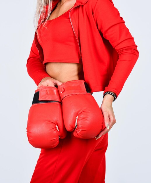 Never give up and keep moving sports woman in tracksuit and boxing gloves fit boxer woman kick off confident young sportswoman posing in boxing gloves slim shaped woman with red boxing gloves