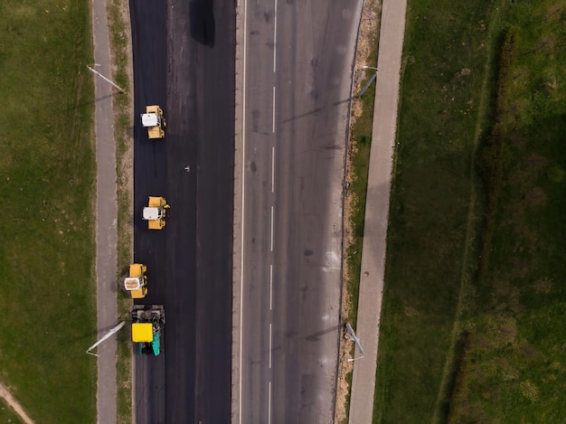 A new asphalt pavement is being laidroad construction equipment is working