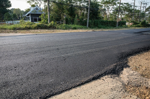 Photo new asphalt tarmac texture road of repairing on the damaged highway in construction site