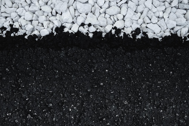 Photo new asphalt on white gravel. top down view flat background of freshly laid asphalt.
