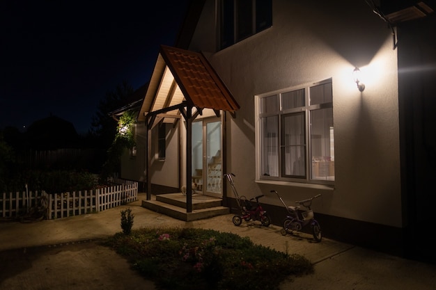 New beautiful house lit by lanterns at night