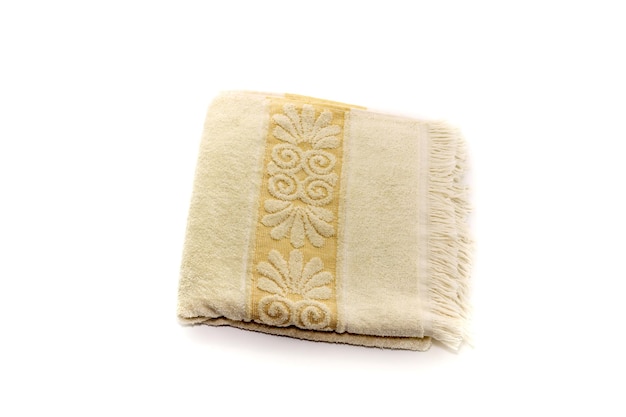 New beige terry towel with a picture on a white background closeup