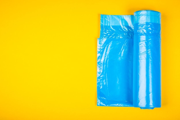 New blue garbage bags on a yellow background