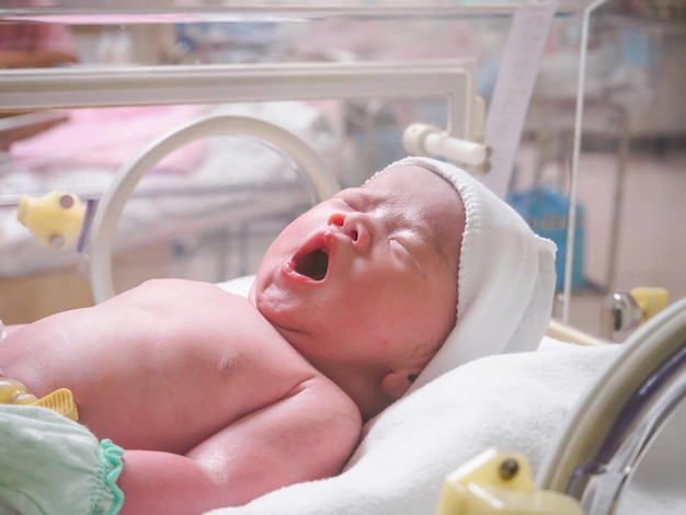 New born baby infant sleep in the incubator at hospital