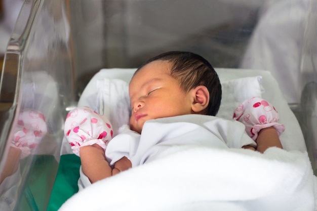 Photo new born infant asleep in the blanket in delivery room