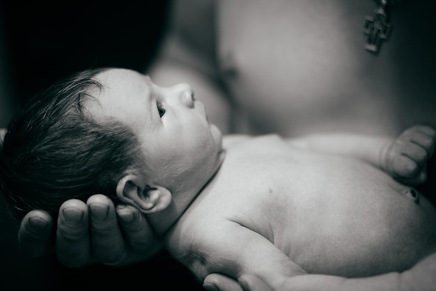 A new boy in his father's arms Black and white