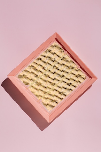 New car air filter on a pink background