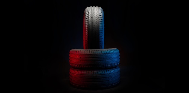 New car tires Group of road wheels on dark background Summer Tires with asymmetric tread design Driving car concept