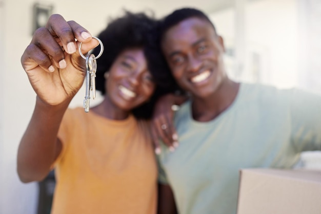 A new chapter starts today Shot of a young couple holding the keys to their new house