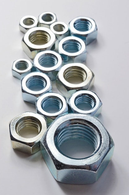 New chrome screw-nut of different sizes. Concept.