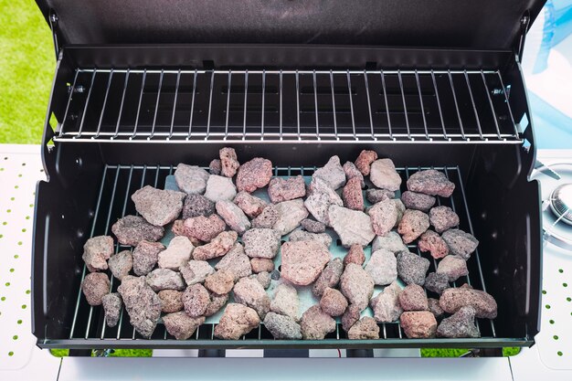 New and clean barbecue grill with lava rocks